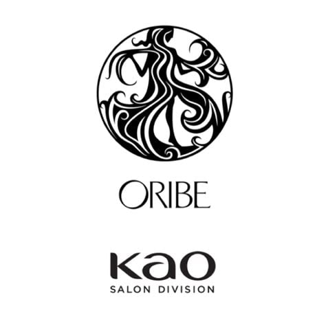 The Oribe brand logo features a stylized, elegant design with intricate lines forming a circular emblem, representing luxury and sophistication in beauty